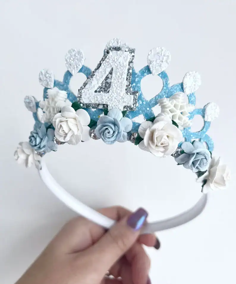 Holding a handmade Frozen themed snowflake tiara.