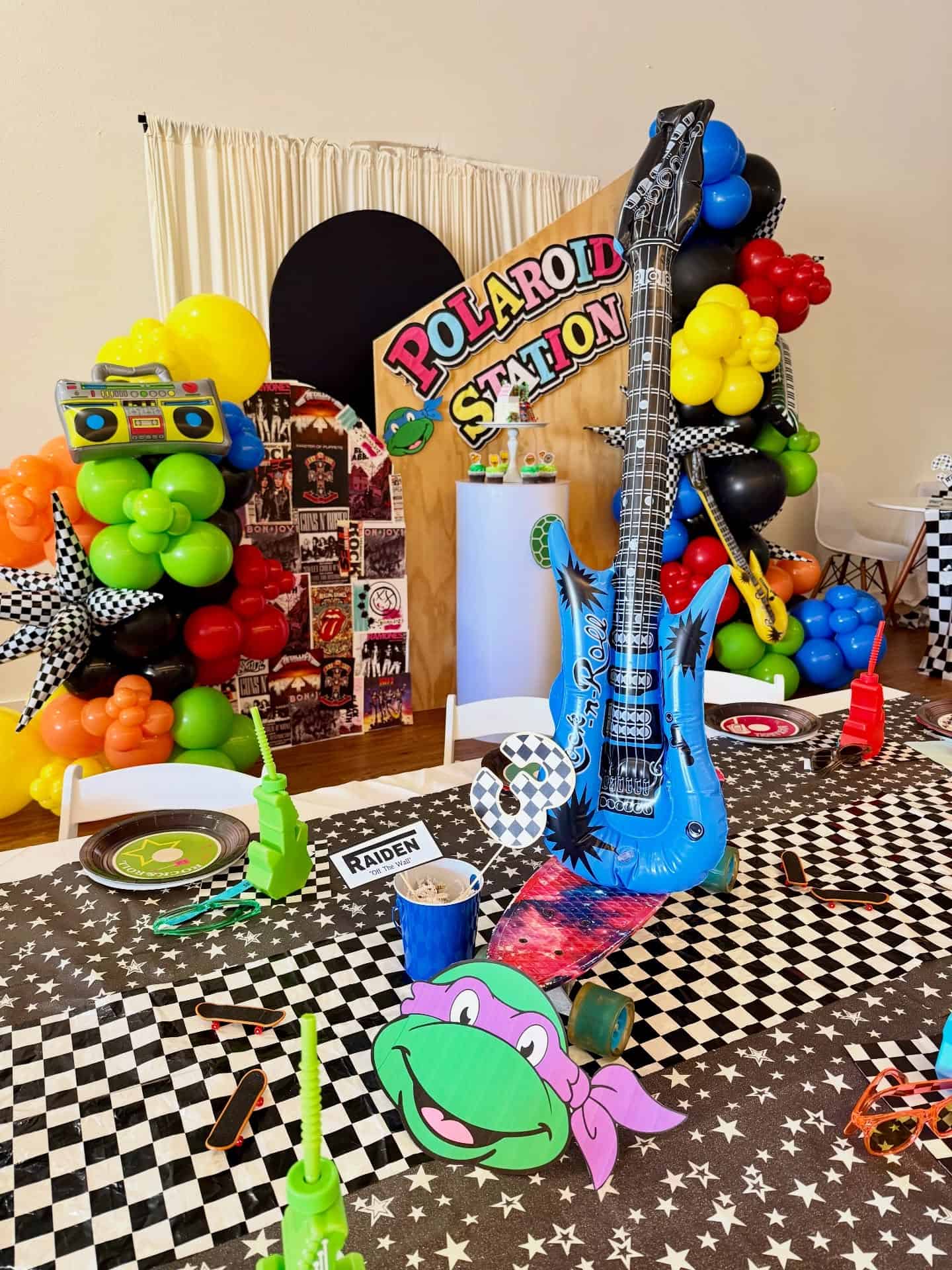 90s Themed Polaroid Station Party Setup with Inflatable Guitars