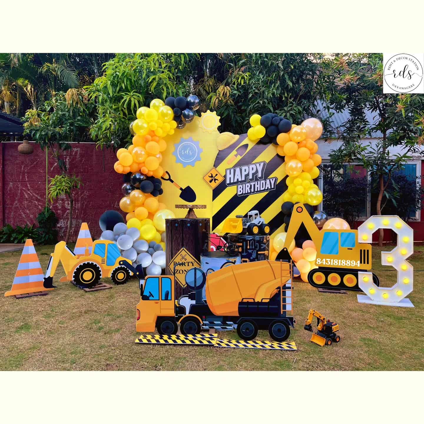 Construction Zone Birthday Setup with Truck Cutouts and Balloon Arch