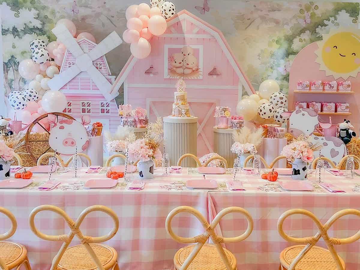 Pink Farm Barnyard Party Setup with Balloons and Desserts