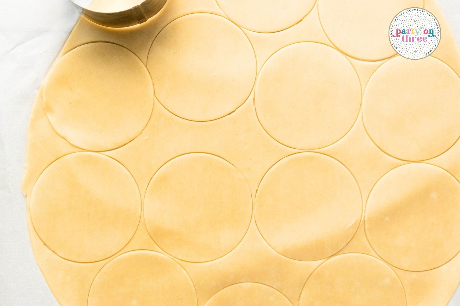Pie dough rolled out with circles cut using a round cutter to prepare apple hand pie shells
