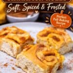 Three baked pumpkin cinnamon rolls on a plate with fall flavor text badge