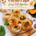 Pumpkin Feta Phyllo Cups on a wooden board styled with fall leaf illustrations and text