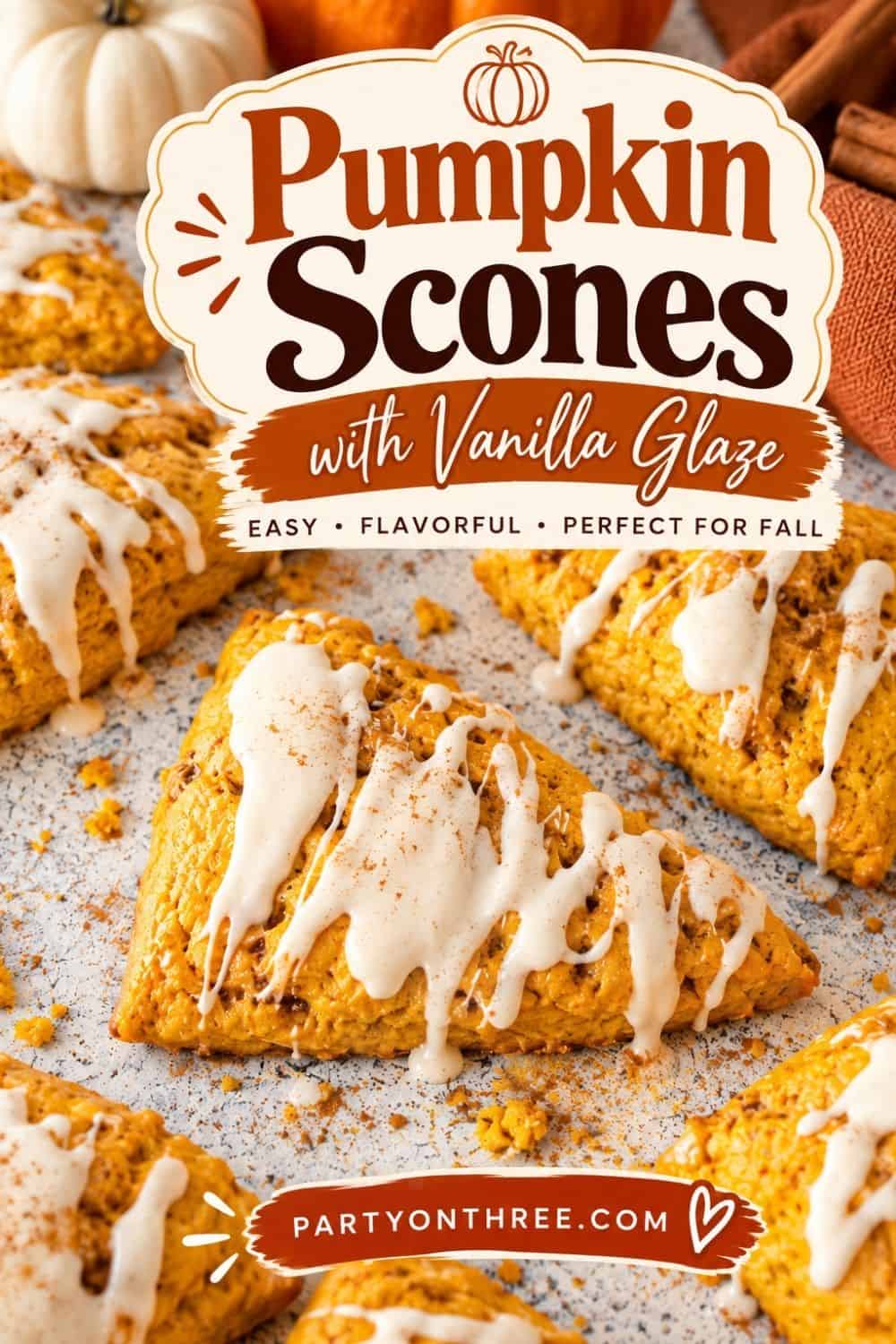 Styled pumpkin scones with vanilla glaze surrounded by mini pumpkins and cinnamon sticks