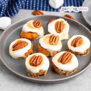 Finished Sweet Potato Bites with toasted marshmallow and pecan topping arranged on a gray plate