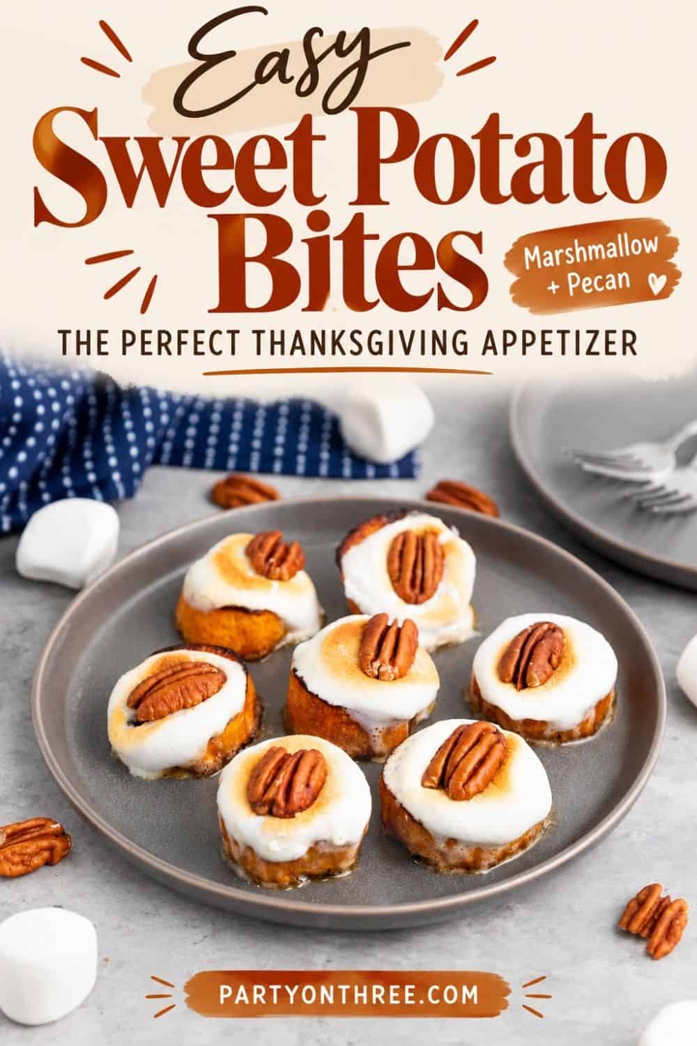 Sweet Potato Bites with marshmallow and pecan on a gray plate, labeled the perfect Thanksgiving appetizer