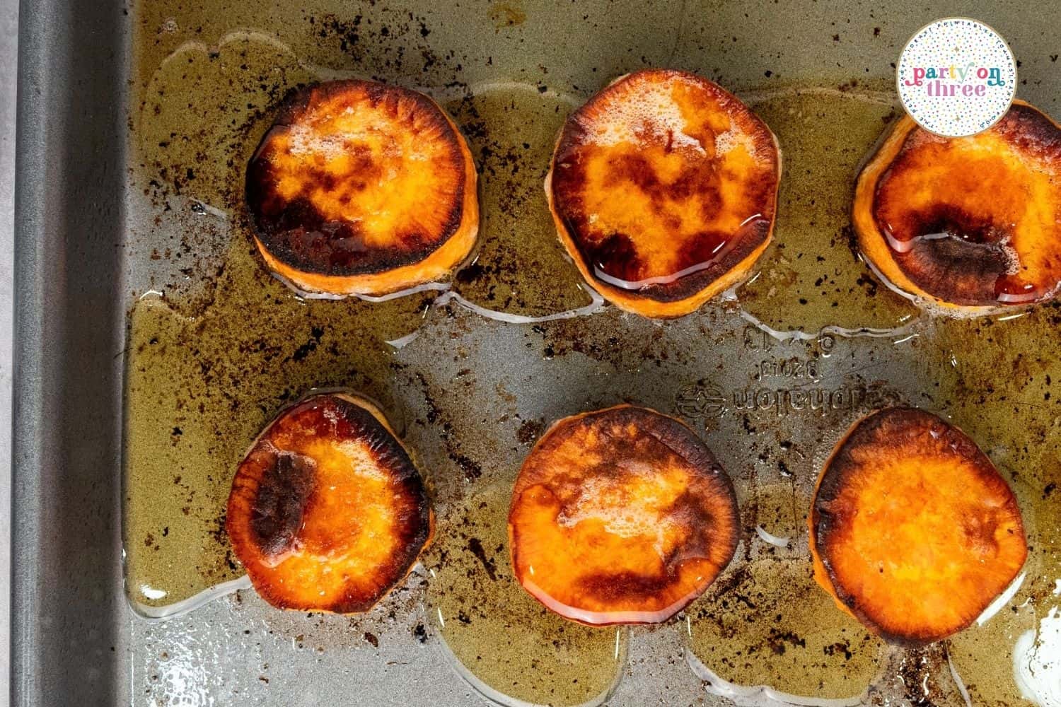 Roasted sweet potato rounds with caramelized edges fresh out of the oven before broiling