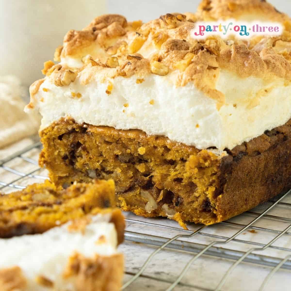 Close-up of chocolate chip sweet potato bread loaf with toasted meringue and walnut topping on a rack