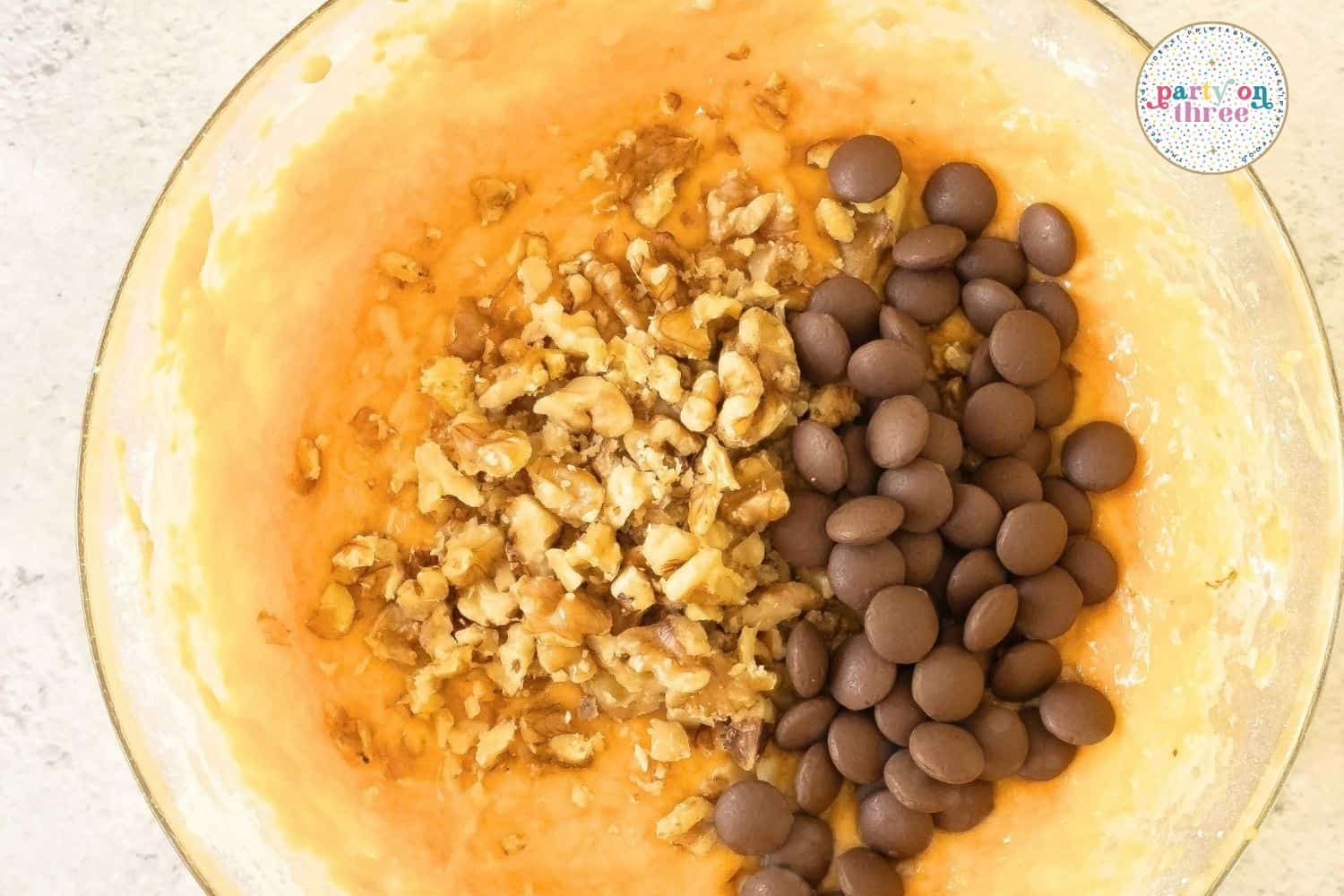 Folding in chocolate chips and walnuts.