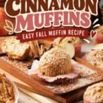 Apple cinnamon muffins with crumble topping on a wooden board, surrounded by apple slices and cinnamon sticks