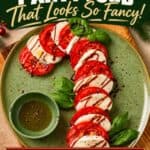 Caprese Candy Cane (Easy Christmas Appetizer) arranged on a green plate with basil and balsamic glaze