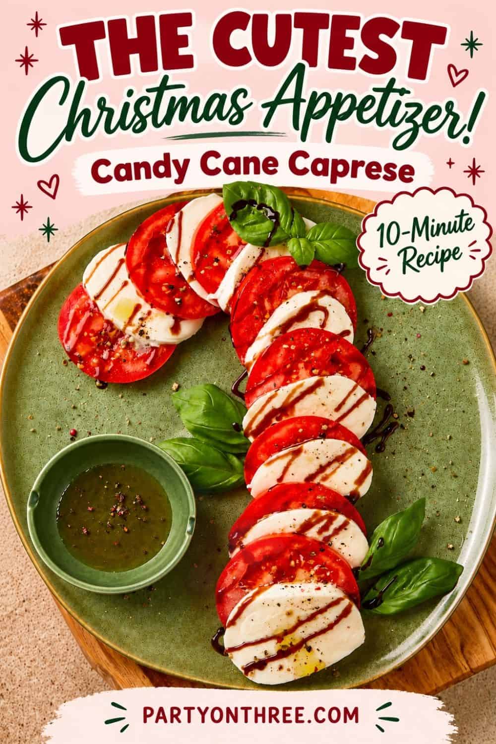 Caprese Candy Cane appetizer with tomato and mozzarella slices, balsamic drizzle, and basil leaves on a green plate
