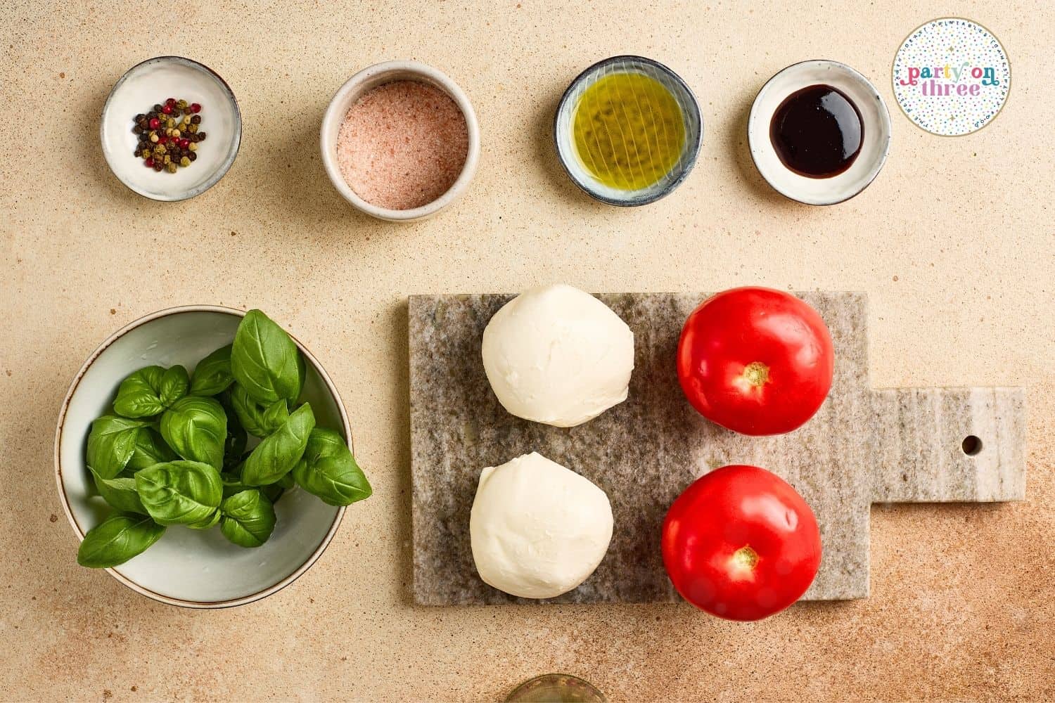Ingredients for Caprese Candy Cane appetizer: mozzarella, tomatoes, basil, salt, pepper, olive oil, and balsamic glaze.
