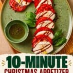 Caprese Candy Cane arranged on a green plate with tomato, mozzarella, basil, and balsamic drizzle