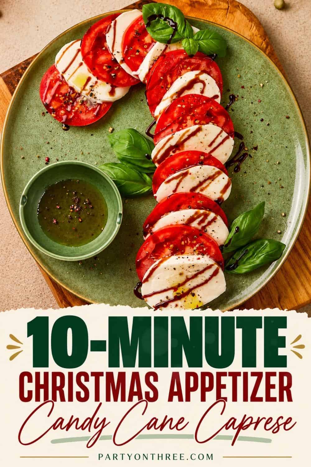 Caprese Candy Cane arranged on a green plate with tomato, mozzarella, basil, and balsamic drizzle