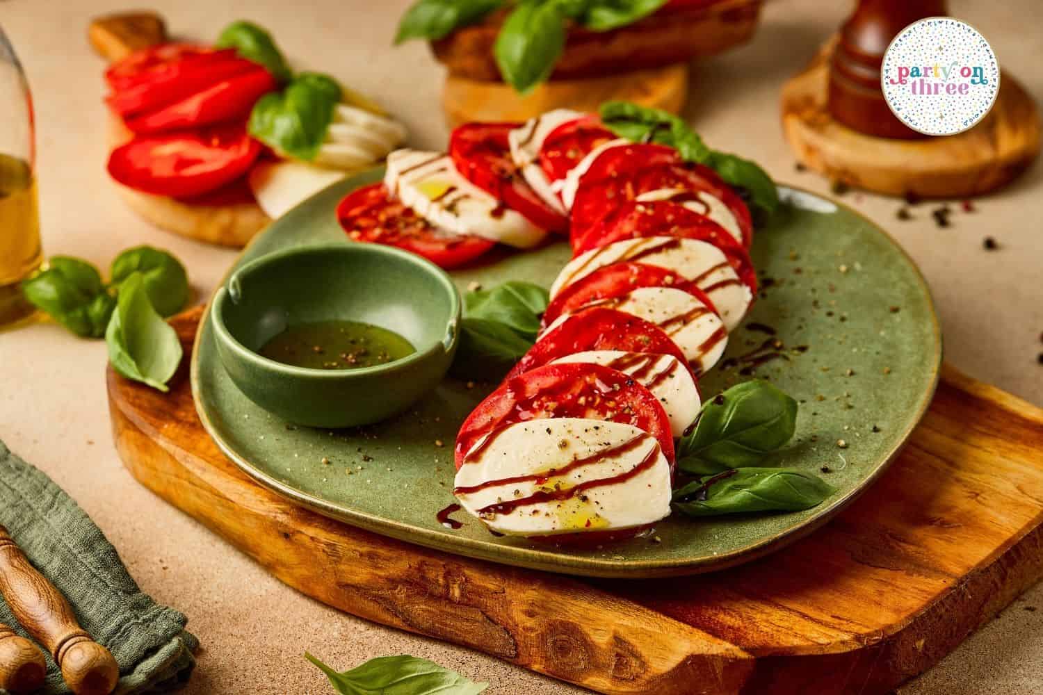 Candy cane shaped mozzarella and tomato slices with basil leaves tucked between, drizzled with balsamic glaze