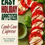 Caprese Candy Cane appetizer arranged on a green plate with basil, balsamic drizzle, and dipping sauce.