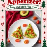Christmas appetizer of triangle pita tree slices topped with mashed avocado and diced tomatoes on a white plate