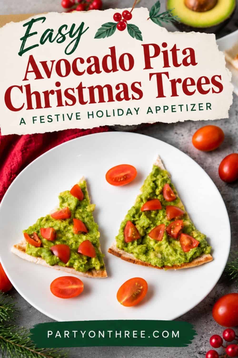 Two pita triangles topped with mashed avocado and diced tomatoes shaped like Christmas trees on a white plate