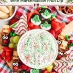 Christmas charcuterie board with marshmallow fruit dip, reindeer pretzels, dipped Oreos, strawberries and sugar cookies