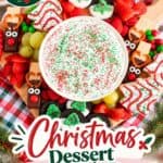 Christmas charcuterie board with marshmallow dip, reindeer pretzels, Oreos, cookies, strawberries and grapes