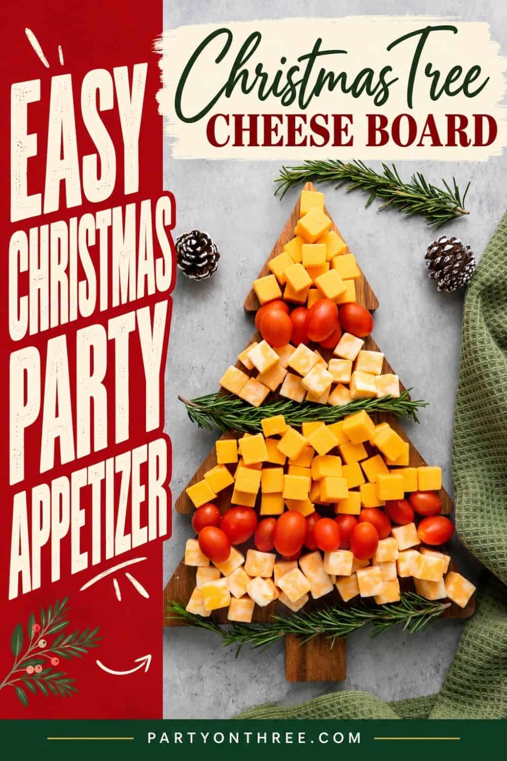 Christmas cheese board shaped like a tree with cheddar cubes, cherry tomatoes, and rosemary sprigs