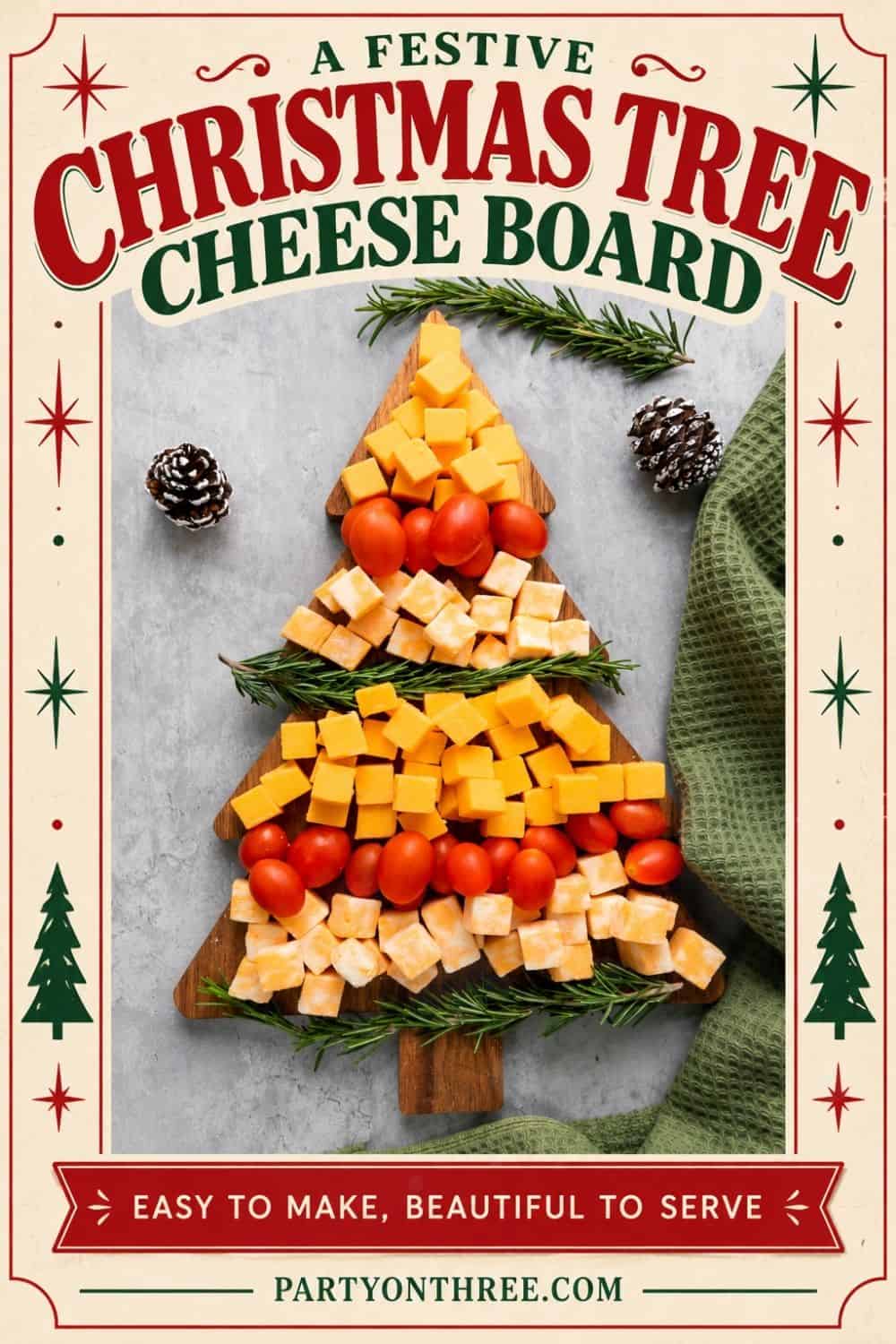 Christmas cheese board arranged in a tree shape with cheddar cubes, cherry tomatoes, and rosemary sprigs