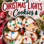 Christmas Light Cookies decorated with white icing and candy bulbs connected by piped black cords, arranged on a tray