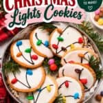 Christmas Light Cookies decorated with white icing and candy "bulbs" connected by piped black wire lines