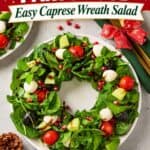 Christmas Wreath Salad shaped with arugula, mozzarella, tomatoes, avocado, olives and pomegranate on a round plate