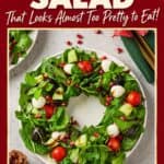 Christmas Wreath Salad with spinach, mozzarella, tomatoes, pomegranate and balsamic drizzle on a white plate