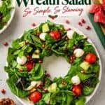 Christmas Wreath Salad arranged in a ring with mozzarella, tomatoes, pomegranate seeds, and balsamic drizzle