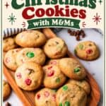 Easy Christmas cookies with red and green M&Ms on a wooden tray, chocolate chips scattered nearby