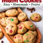 Easy Christmas cookies with red and green M&M's on a wooden tray, chocolate chips scattered nearby
