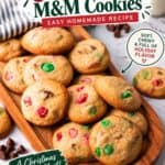 Easy Christmas cookies with red and green M&Ms piled on a wooden board for holiday baking