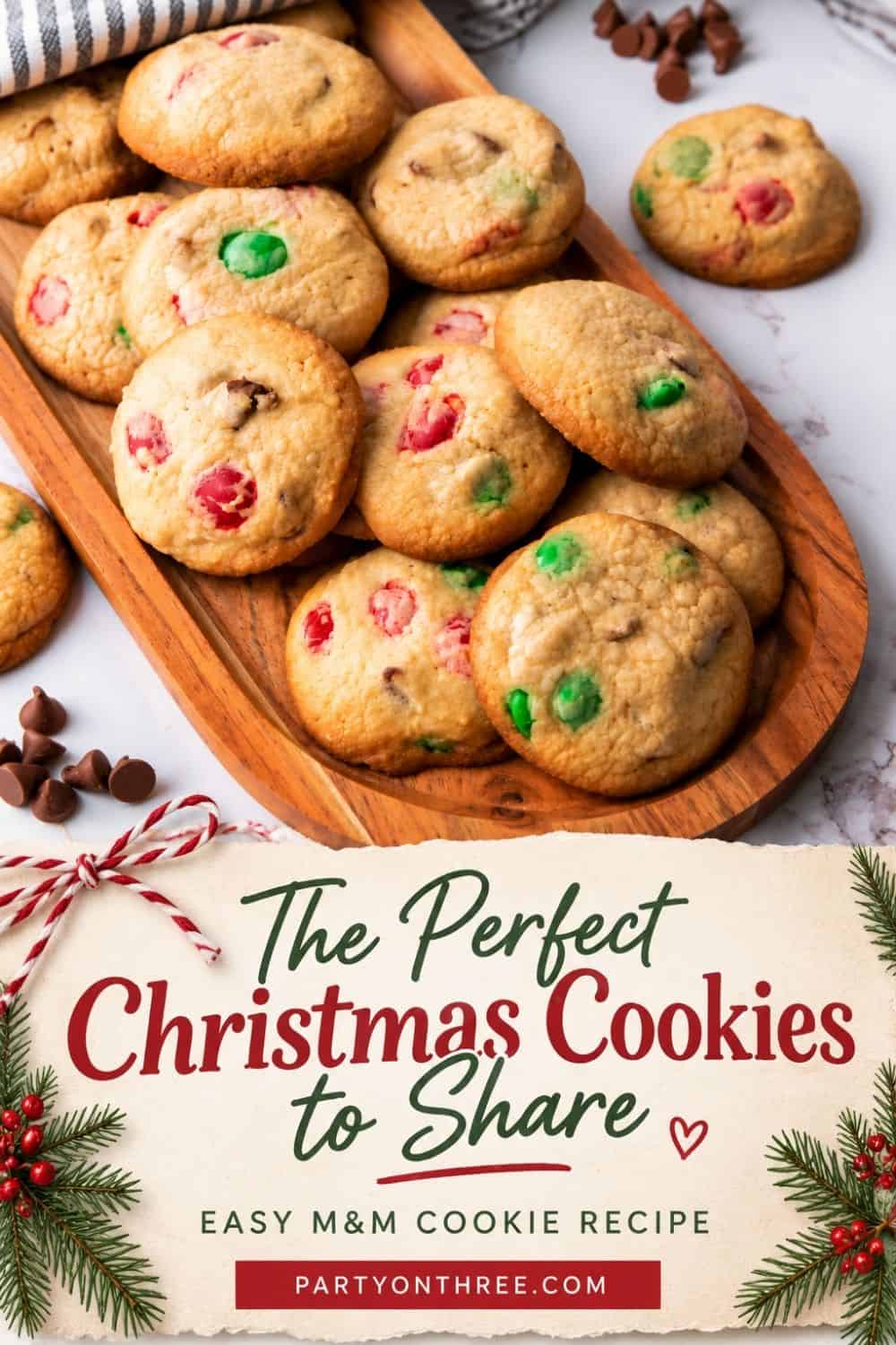 Easy Christmas cookies with red and green M&M candies piled on a wooden tray with chocolate chips