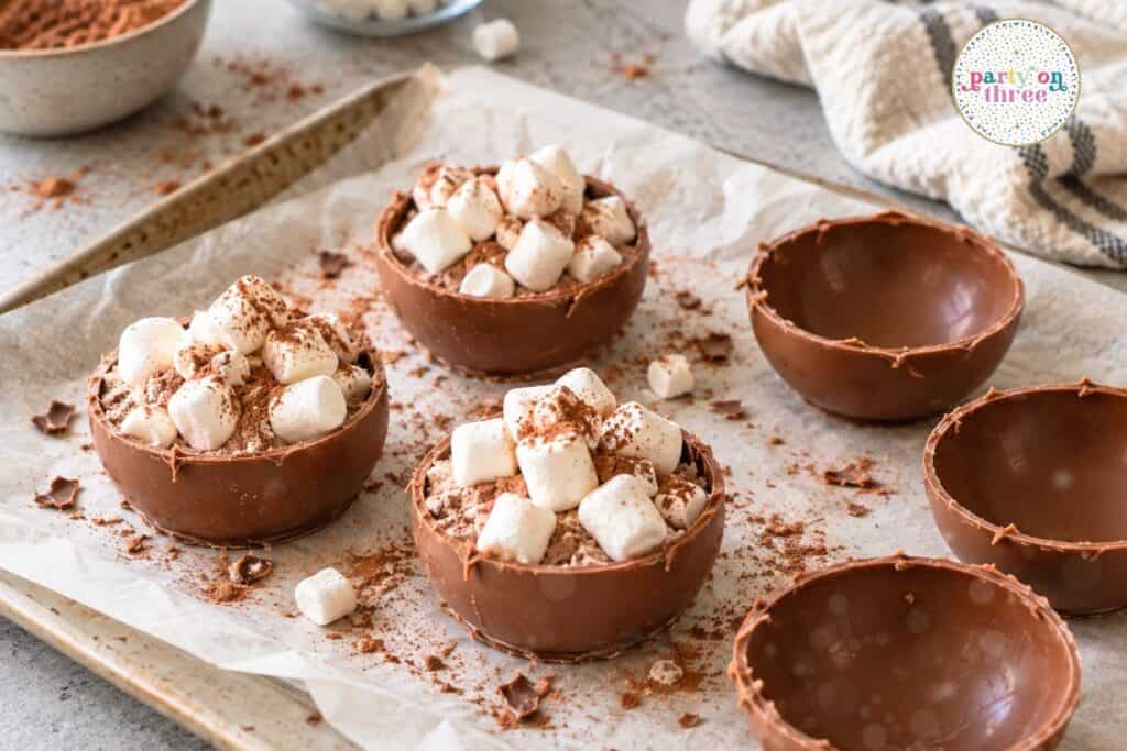 Chocolate shells filled with hot cocoa mix and mini marshmallows.