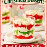 Mini Christmas Trifle Cups with layered red and green cake, whipped cream, in glass cups on a plate.