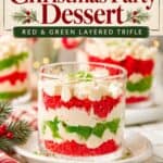 Mini Christmas Trifle Cups with layered red and green cake, whipped cream, and berries in glasses