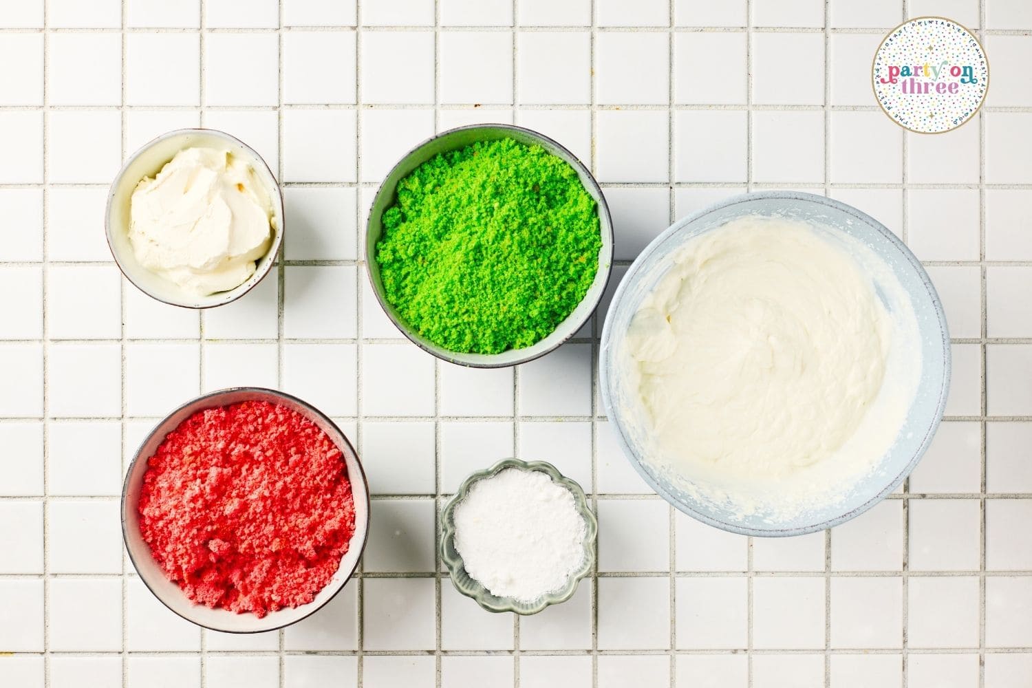 Ingredients for Mini Christmas Trifle Cups: whipped topping, red and green cake crumbs, sugar, and cream filling