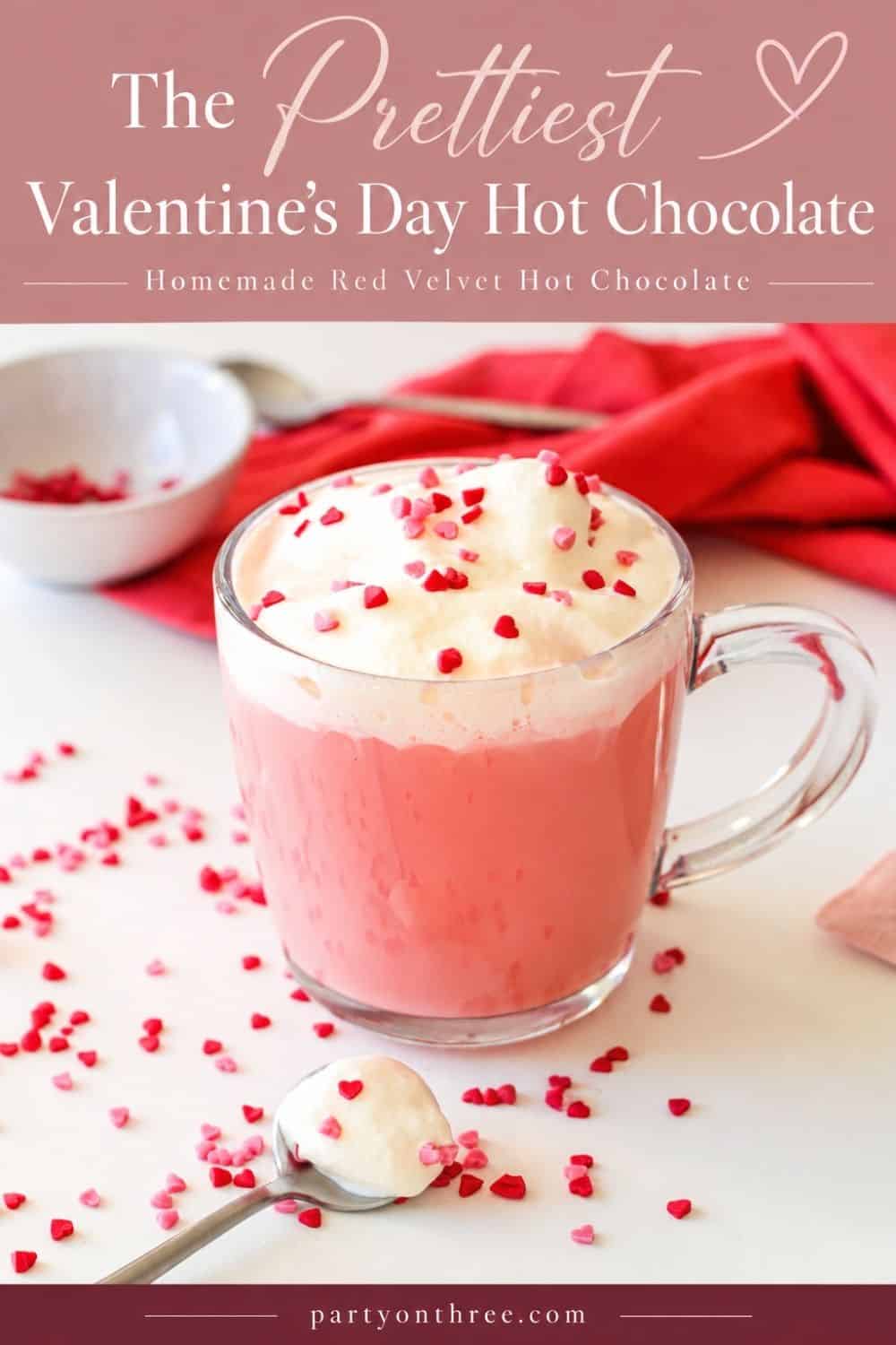 Valentine’s Day hot chocolate, pink and topped with whipped cream and heart sprinkles