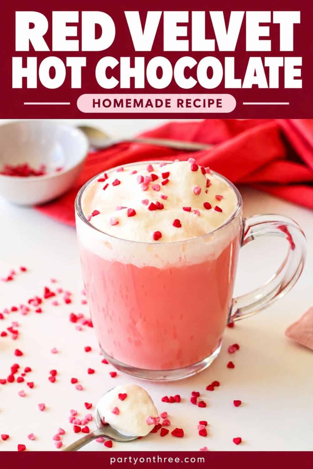 Homemade red velvet hot chocolate topped with whipped cream and heart sprinkles