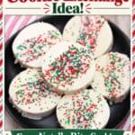 White chocolate-dipped Ritz Cracker Christmas cookies with red, green, and white sprinkles on a black plate