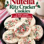 White chocolate-dipped Ritz Cracker Christmas Cookies with red and green sprinkles on a black plate