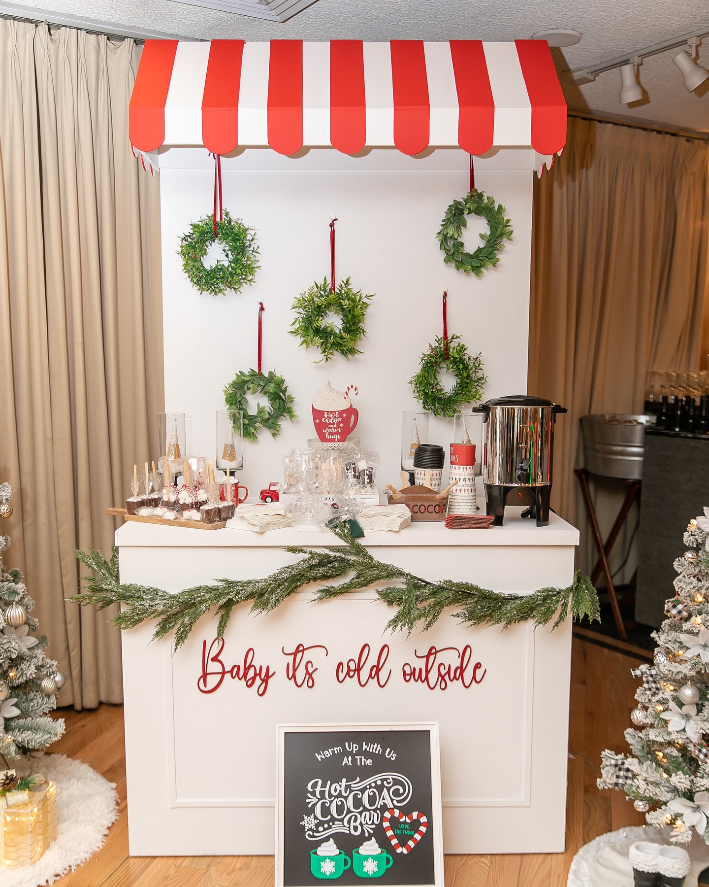 Striped Awning Cocoa Stand With Hanging Wreaths
